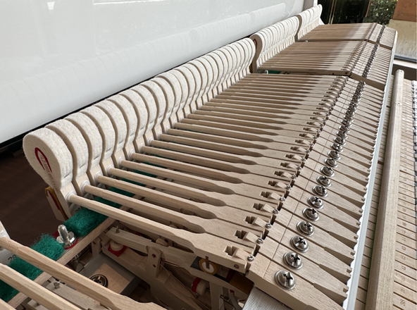 white baby grand piano with hardwood action