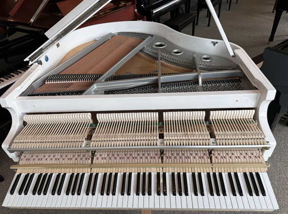 white baby grand piano oveview