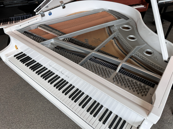 white baby grand piano with nickel estero